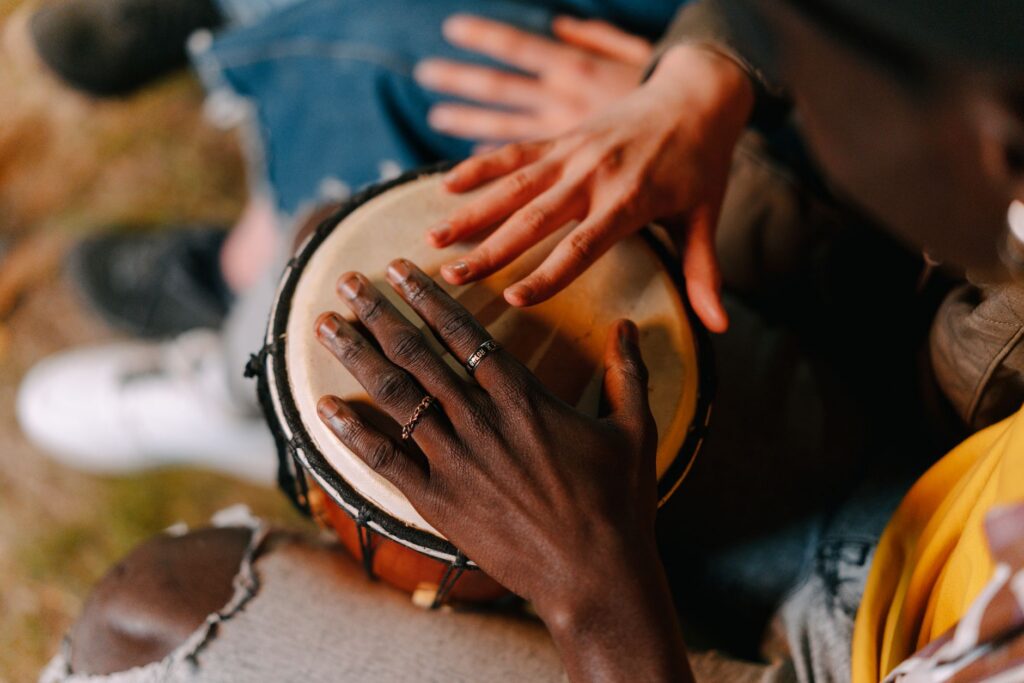 Hands playing a drum, community drum circle at Posse Grounds Park Sedona this Saturday