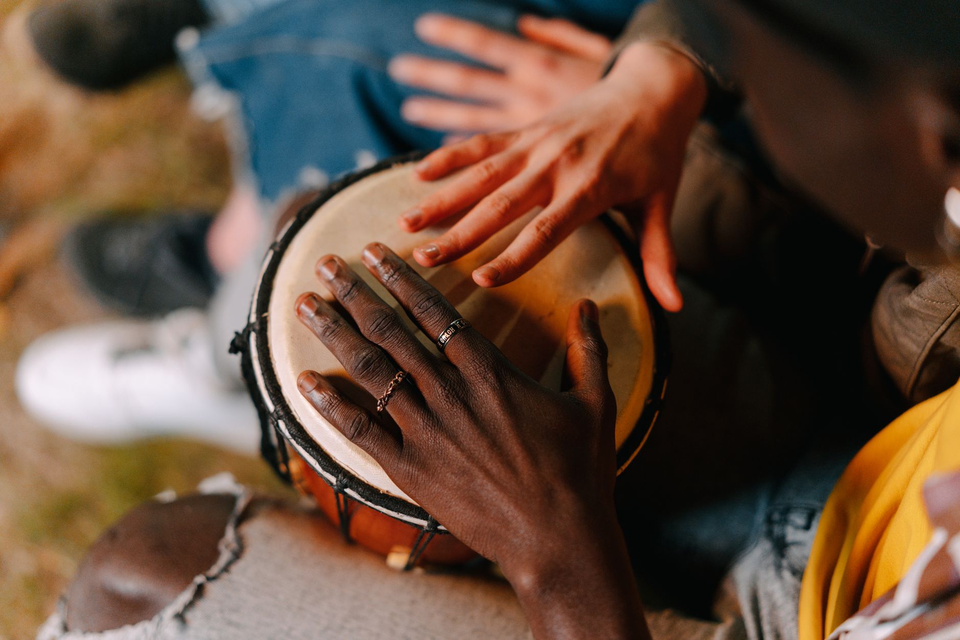 Hands playing a drum, community drum circle at Posse Grounds Park Sedona this Saturday